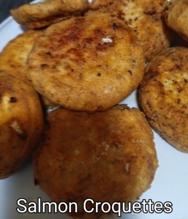 Salmon Croquettes Fried salmon croquettes arranged on a plate, golden brown and crispy.